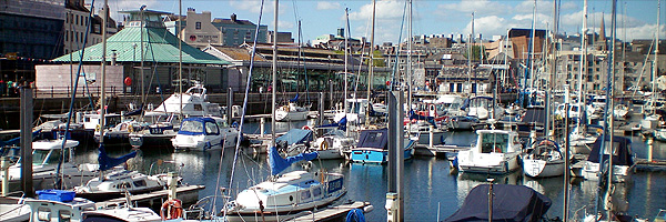 Plymouth's historic barbican taken from the quayside with the city centre in the background 