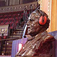 Image of bust of Henry Wood wearing ear defenders