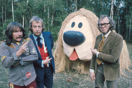 The Goodies being chased by a giant rampaging Dougal (from The Magic Roundabout).