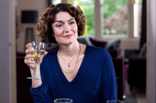 Laura's mum (Anna Chancellor) drinks a glass of wine