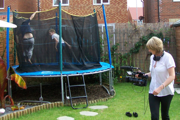 Liz Bloor films the Hobley children on the trampoline in their back garden
