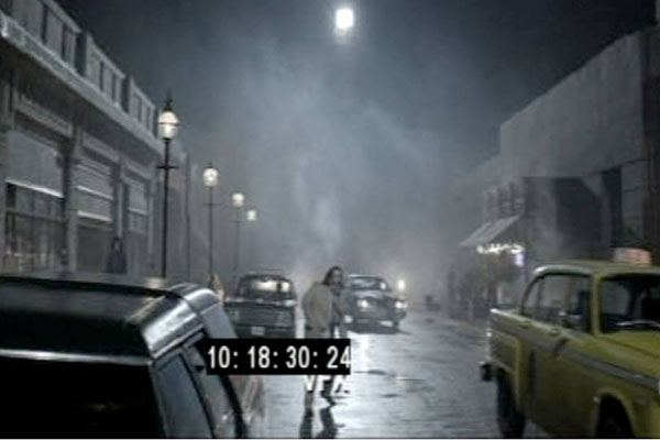 A screenshot of Nick Frost crossing the road on the set of Money before the special effects and CGI were added to the background