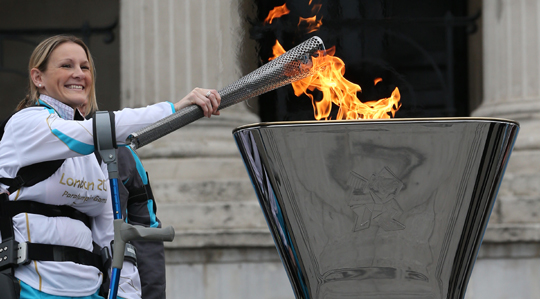 Disabled marathon runner Claire Lomas lights the Olympic cauldron for the Paralympic Games.