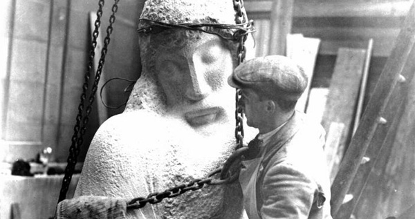 A man assembling the statue of Prospero and Ariel on the facade of BBC Broadcasting House in 1932.