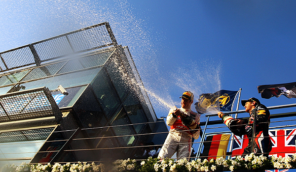 Jenson Button and Sebastian Vettel celebrate on the podium at the 2012 Australian Grand Prix in Melbourne.