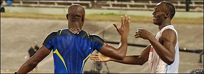 Asafa Powell congratulates world record holder Usain Bolt following their men's 100 meter final on June 28, 2008 at the Jamaica Olympic trials in Kingston.